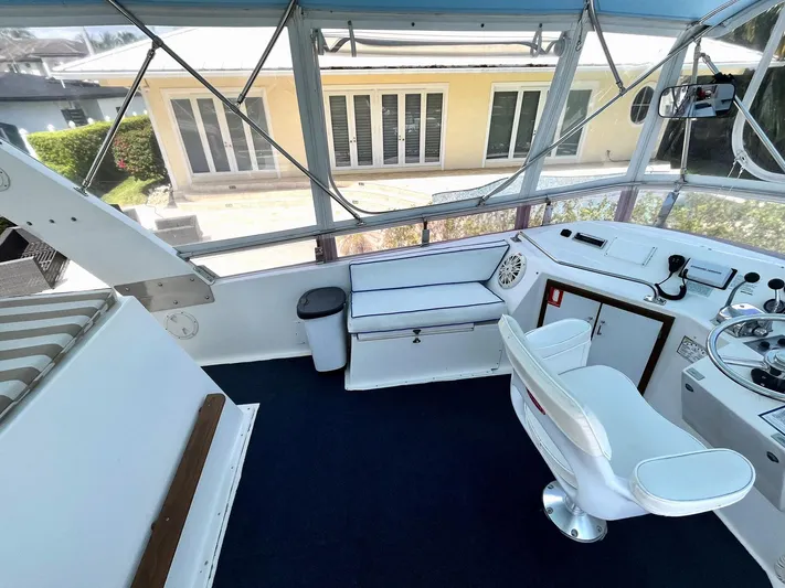 Sea Fever Yacht Photos Pics 1987 Symbol 44 Sun Deck MK II yacht interior with helm, seating, and panoramic windows.