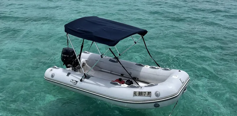 Sea Fever Yacht Photos Pics Inflatable boat with canopy on clear turquoise water, Symbol 44 Sun Deck MK II, 1987 model.