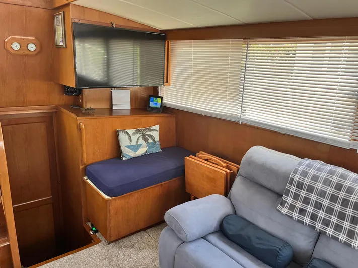 Sea Fever Yacht Photos Pics Cozy interior of 1987 Symbol 44 Sun Deck MK II with seating and TV.