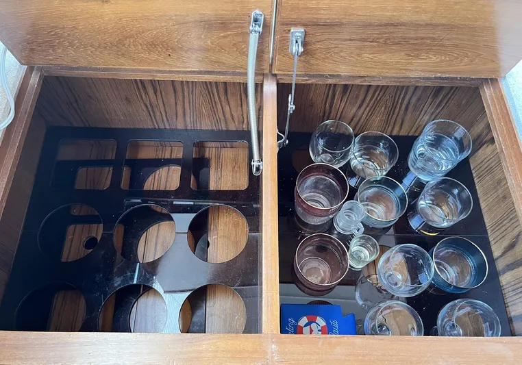 Sea Fever Yacht Photos Pics Cabinet with glass holders and assorted glasses on a 1987 Symbol 44 Sun Deck MK II.