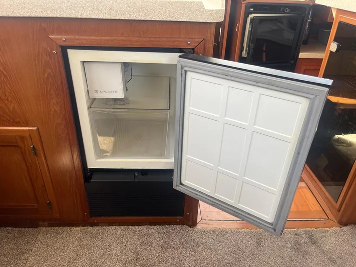 Sea Fever Yacht Photos Pics Open mini fridge on 1987 Symbol 44 Sun Deck MK II yacht interior.