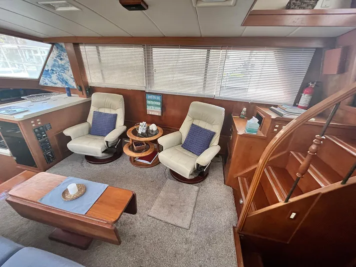Sea Fever Yacht Photos Pics Interior of 1987 Symbol 44 Sun Deck MK II yacht with cozy seating and wooden accents.