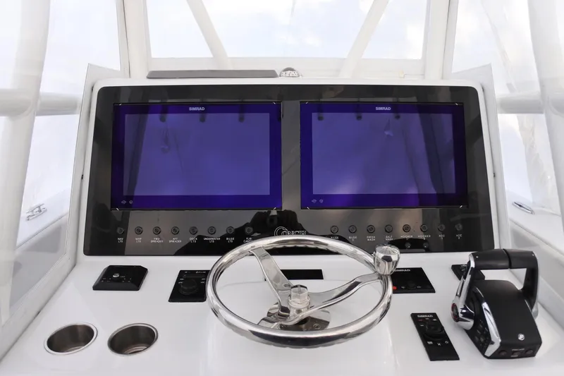  Yacht Photos Pics Helm of 2022 Conch 33 boat with dual Simrad displays and steering wheel.