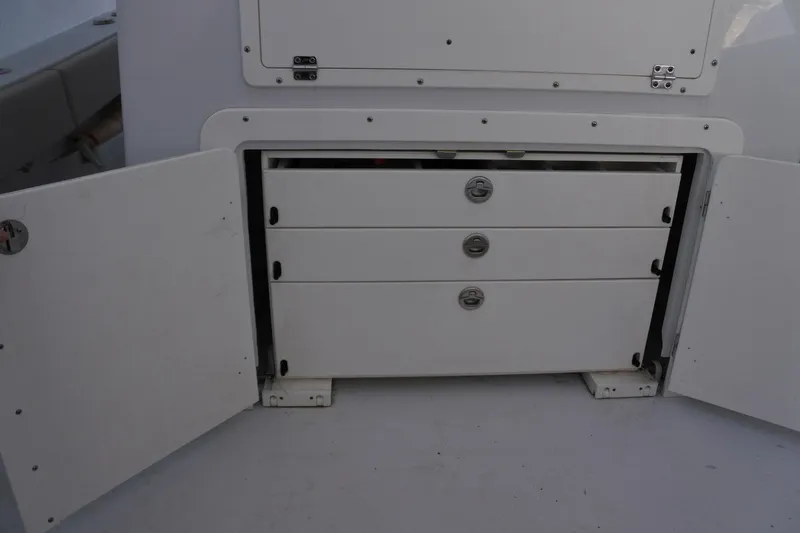  Yacht Photos Pics Open storage compartment with three drawers on a 2022 Conch 33 boat.