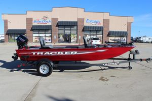 2025 Tracker Panfish 17 boat in red, parked outside a dealership.