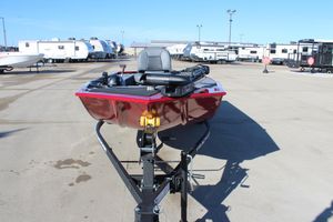 2025 Tracker Panfish 17 boat on trailer, parked in lot with RVs in background.