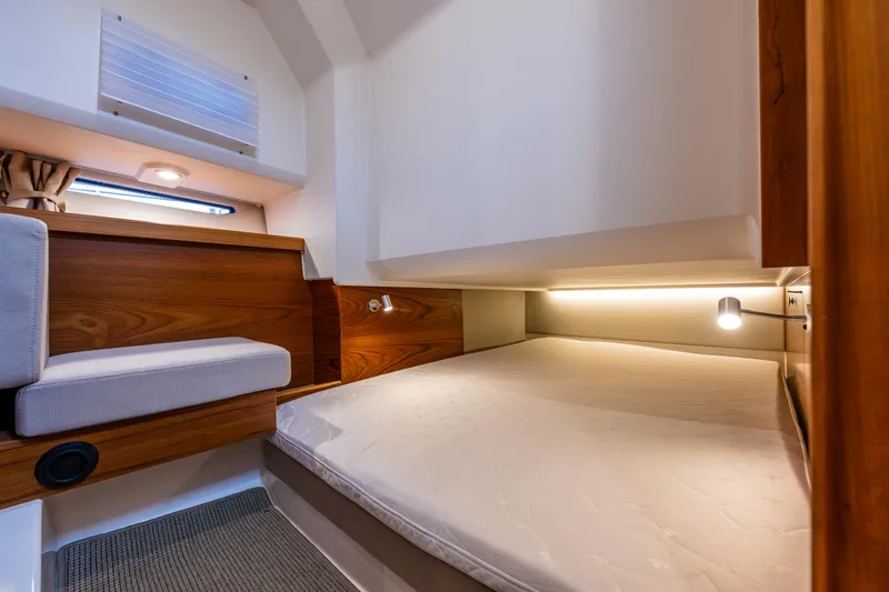 Rylea Rose Yacht Photos Pics Cozy cabin interior of 2021 Nimbus C11 boat with wooden accents and soft lighting.