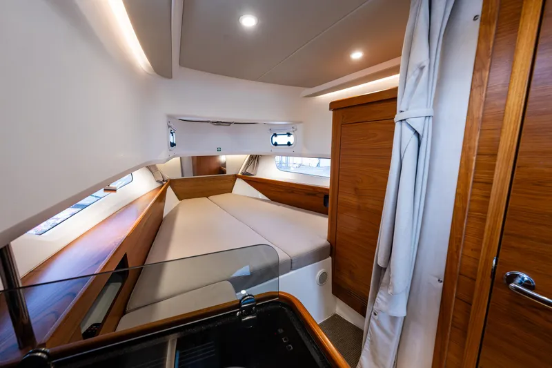 Rylea Rose Yacht Photos Pics Luxurious cabin interior of 2021 Nimbus C11 yacht with wood accents and cozy bed.