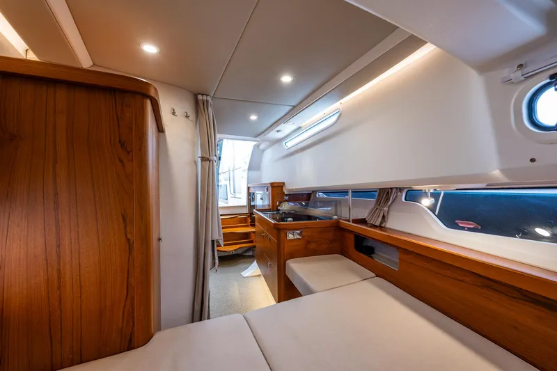 Rylea Rose Yacht Photos Pics Luxurious interior of 2021 Nimbus C11 boat with wooden accents and modern lighting.