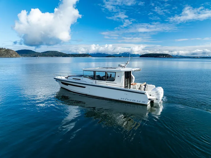 Rylea Rose Yacht Photos Pics Nimbus C11 2021 boat cruising on a serene lake under a blue sky.