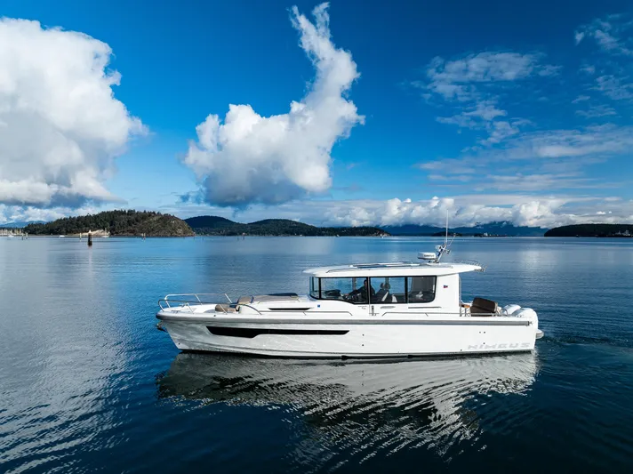 Rylea Rose Yacht Photos Pics Nimbus C11 2021 boat cruising on a serene lake under a blue sky.