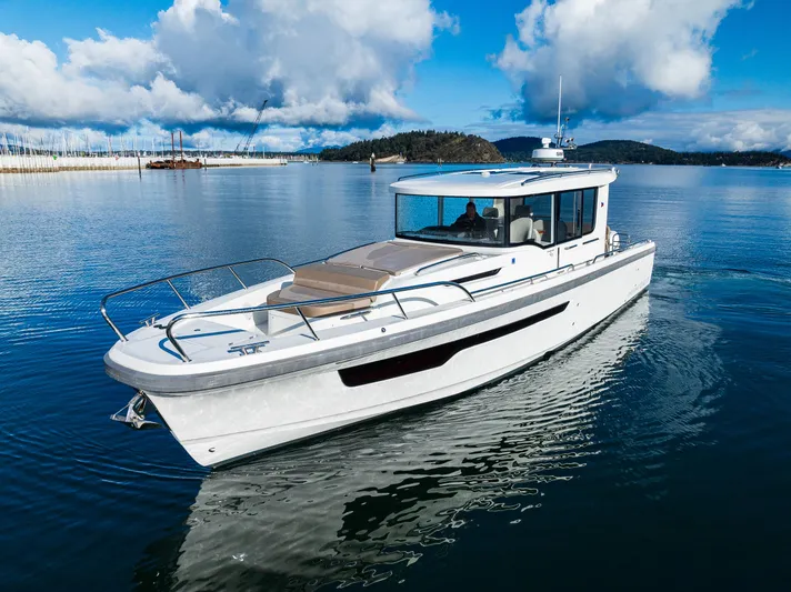 Rylea Rose Yacht Photos Pics Nimbus C11 2021 boat cruising on a serene lake under a blue sky.