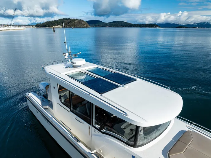 Rylea Rose Yacht Photos Pics Nimbus C11 2021 boat cruising on serene blue waters under a clear sky.