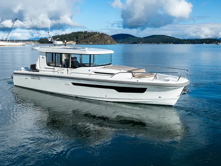 Rylea Rose Yacht Photos Pics Nimbus C11 2021 boat cruising on a serene lake with scenic mountain backdrop.