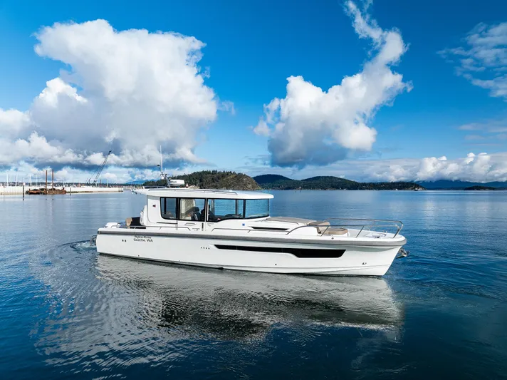 Rylea Rose Yacht Photos Pics Nimbus C11 2021 boat cruising on a serene lake under a blue sky.
