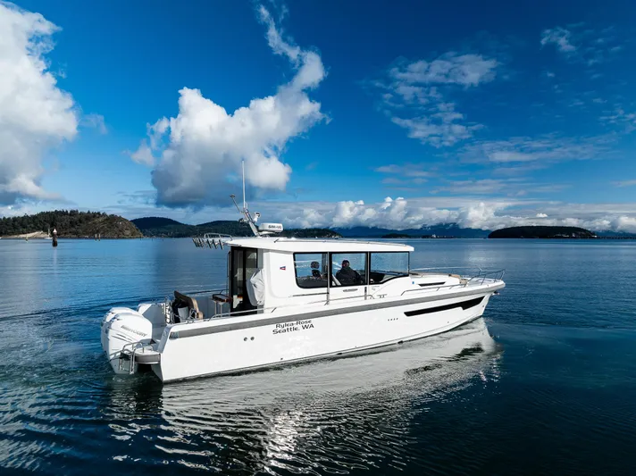 Rylea Rose Yacht Photos Pics Nimbus C11 2021 boat cruising on a serene lake under a clear blue sky.