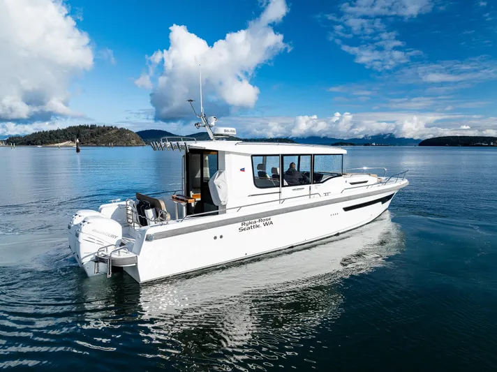 Rylea Rose Yacht Photos Pics Nimbus C11 2021 boat cruising on a serene lake under a blue sky.
