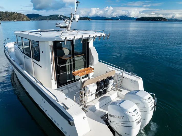 Rylea Rose Yacht Photos Pics Nimbus C11 2021 boat cruising on serene waters with scenic island backdrop.