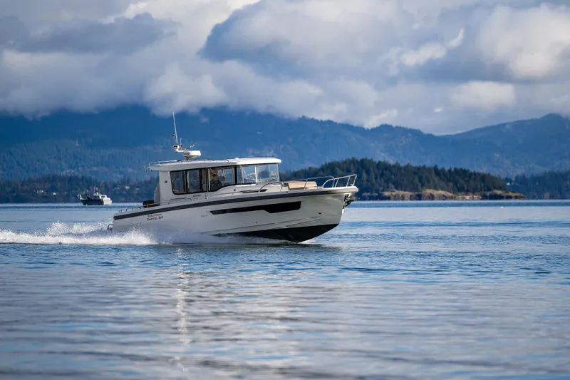 Rylea Rose Yacht Photos Pics Nimbus C11 2021 boat cruising on a serene lake with mountainous backdrop.