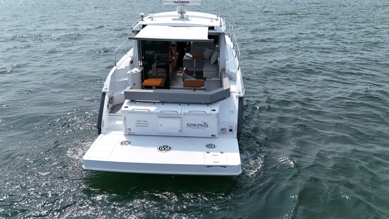 2023 Cruisers 42 Cantius Yacht Photos Pics 2023 Cruisers Yachts 42 Cantius on open water, rear view showcasing deck and seating area.