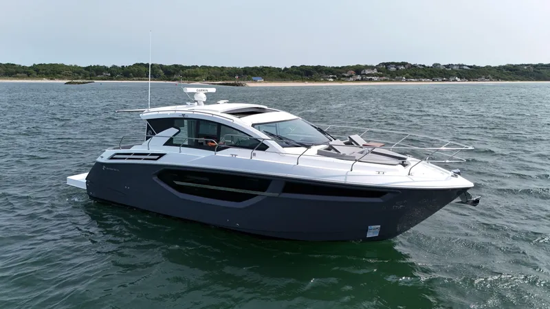2023 Cruisers 42 Cantius Yacht Photos Pics 2023 Cruisers Yachts 42 Cantius on open water, sleek design, coastal background.