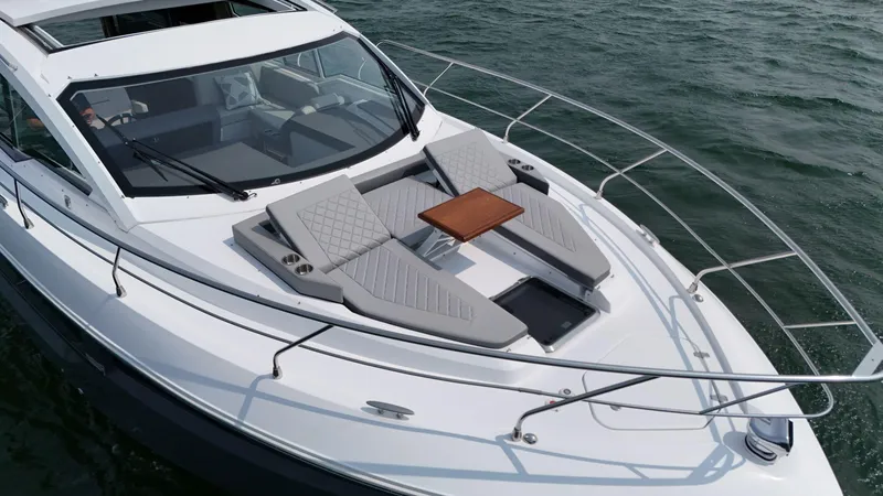 2023 Cruisers 42 Cantius Yacht Photos Pics 2023 Cruisers Yachts 42 Cantius with sun loungers and table on deck, cruising on water.