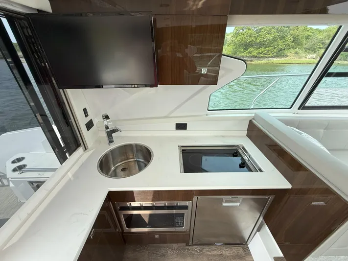 2023 Cruisers 42 Cantius Yacht Photos Pics 2023 Cruisers Yachts 42 Cantius kitchen with sink, stove, and modern appliances.