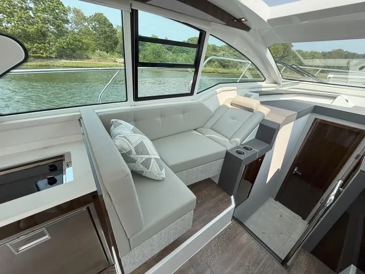 2023 Cruisers 42 Cantius Yacht Photos Pics Luxurious interior of 2023 Cruisers Yachts 42 Cantius with plush seating and scenic water view.