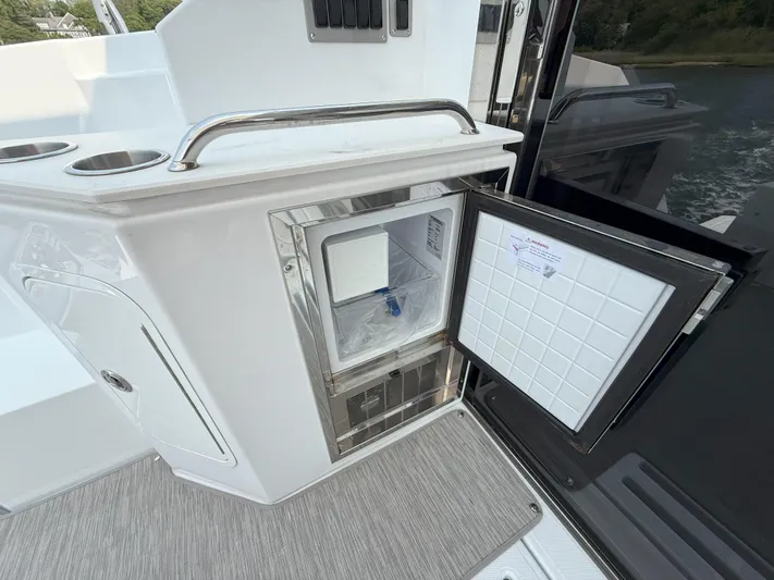 2023 Cruisers 42 Cantius Yacht Photos Pics 2023 Cruisers Yachts 42 Cantius with open mini fridge on deck.