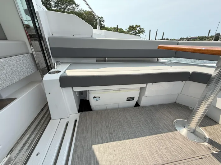 2023 Cruisers 42 Cantius Yacht Photos Pics 2023 Cruisers Yachts 42 Cantius seating area with integrated cooler and table.