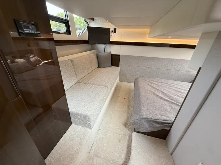 2023 Cruisers 42 Cantius Yacht Photos Pics Interior of 2023 Cruisers Yachts 42 Cantius, featuring modern seating and cozy bedding.