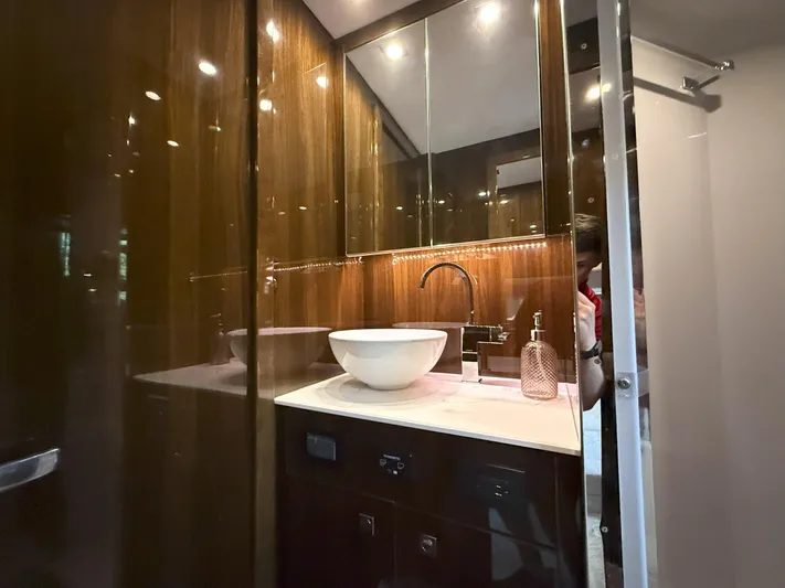 2023 Cruisers 42 Cantius Yacht Photos Pics Luxurious bathroom interior of 2023 Cruisers Yachts 42 Cantius with modern sink and wood paneling.