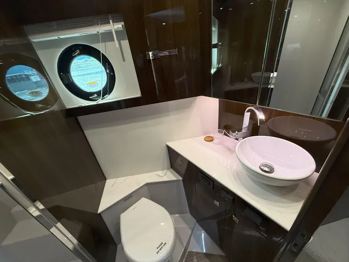2023 Cruisers 42 Cantius Yacht Photos Pics Luxurious bathroom in 2023 Cruisers Yachts 42 Cantius, featuring modern sink and porthole window.