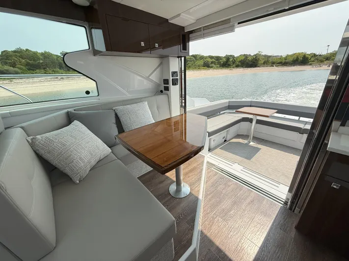 2023 Cruisers 42 Cantius Yacht Photos Pics Luxurious interior of 2023 Cruisers Yachts 42 Cantius with elegant seating and scenic water view.