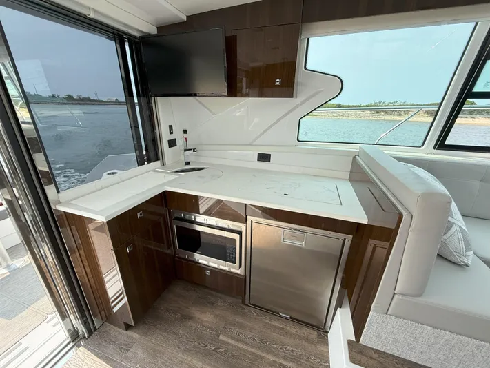 2023 Cruisers 42 Cantius Yacht Photos Pics 2023 Cruisers Yachts 42 Cantius interior kitchen with modern appliances and waterfront view.