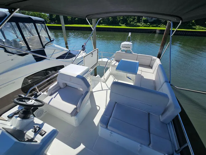  Yacht Photos Pics 2024 Beneteau Antares 12 yacht interior with seating and navigation equipment on a sunny day.