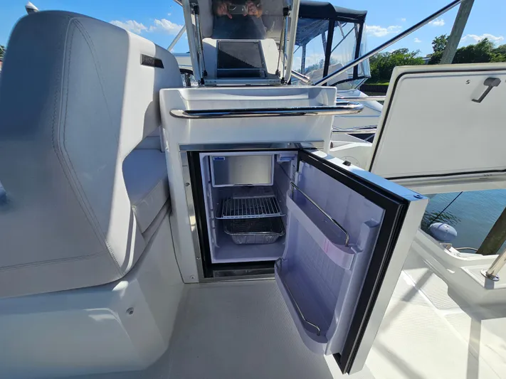  Yacht Photos Pics 2024 Beneteau Antares 12 boat interior with open mini fridge, showcasing modern amenities.