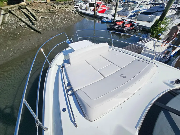  Yacht Photos Pics 2024 Beneteau Antares 12 boat with sunbathing deck, docked in marina.