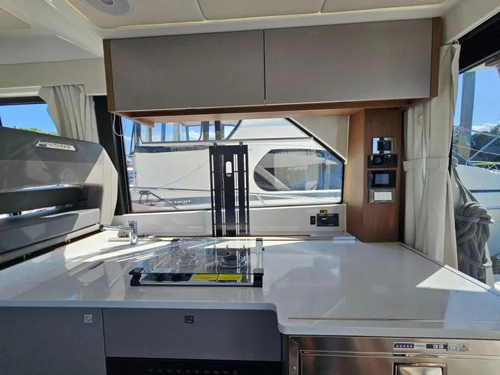 Yacht Photos Pics Interior of 2024 Beneteau Antares 12 yacht, featuring modern kitchen and control panel.