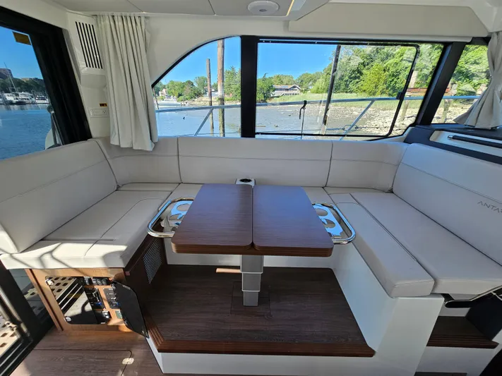  Yacht Photos Pics Luxurious interior of 2024 Beneteau Antares 12 yacht with elegant seating and scenic window views.