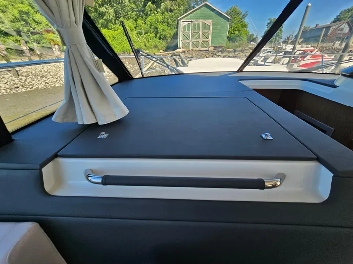  Yacht Photos Pics Interior view of 2024 Beneteau Antares 12 yacht, featuring sleek design and window curtains.