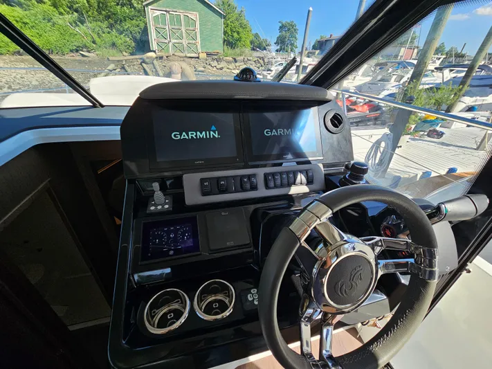  Yacht Photos Pics 2024 Beneteau Antares 12 helm with Garmin navigation system and modern controls.