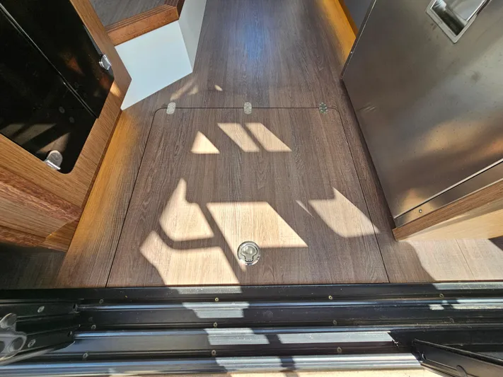  Yacht Photos Pics Interior view of 2024 Beneteau Antares 12, featuring sleek wooden flooring and modern design elements.