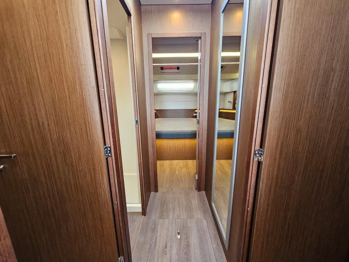  Yacht Photos Pics 2024 Beneteau Antares 12 interior cabin with wood finish and modern design.