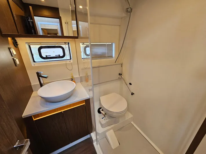  Yacht Photos Pics 2024 Beneteau Antares 12 bathroom with modern fixtures and sleek design.