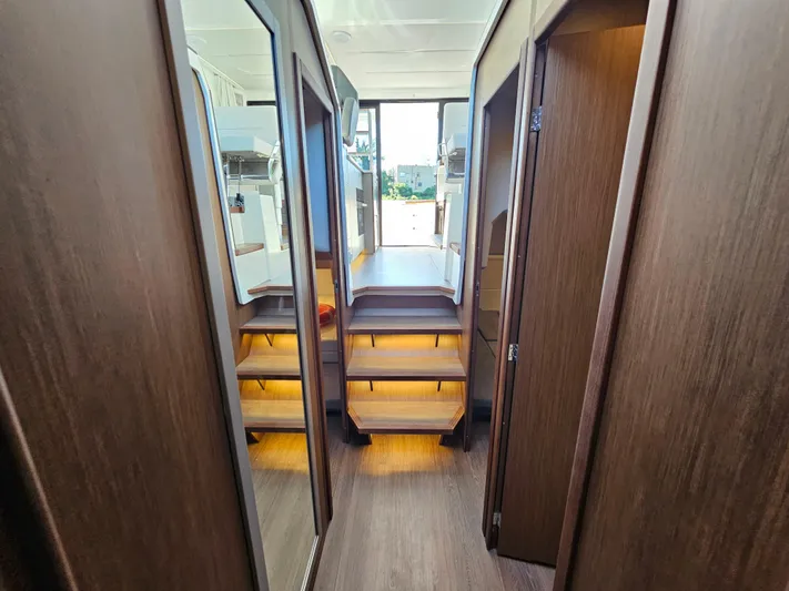  Yacht Photos Pics Luxurious interior of 2024 Beneteau Antares 12 yacht with wooden finishes and modern design.