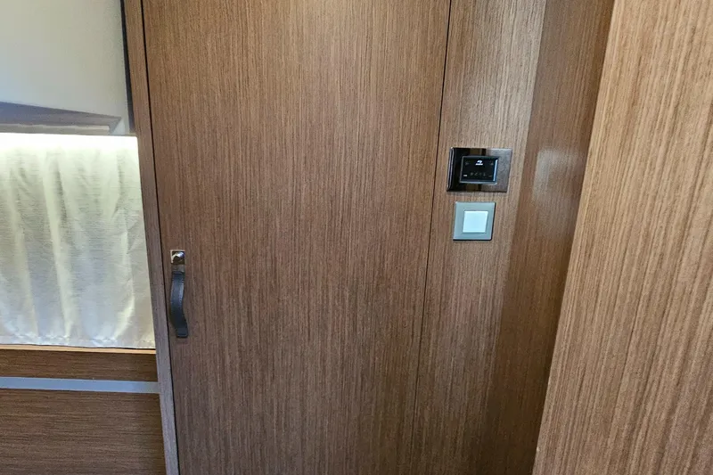  Yacht Photos Pics Interior of 2024 Beneteau Antares 12, featuring wooden paneling and modern controls.