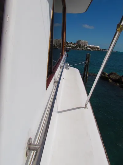 Yacht Photos Pics 1972 Hargrave 67 Motor Yacht deck view with ocean and cityscape background.