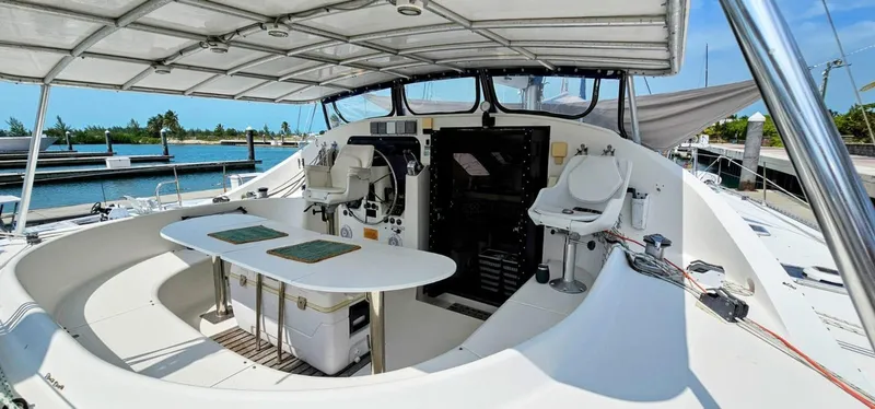  Yacht Photos Pics Lagoon 42 catamaran cockpit, 1994 model, featuring seating and helm under a canopy.