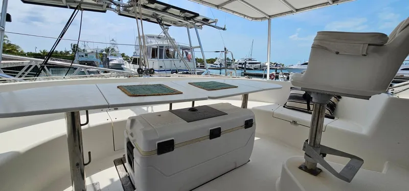  Yacht Photos Pics Lagoon 42 yacht deck with seating and table, docked at marina, 1994 model.